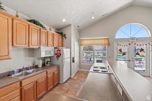 3304 S Hunter Villa Ln Unit D, West Valley City, UT 84128 - kitchen with white appliances, lofted ceiling, healthy amount of natural light, french doors, and recessed lighting