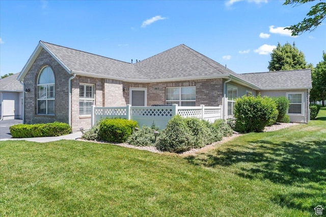 3304 S Hunter Villa Ln Unit D, West Valley City, UT 84128 - ranch-style house with a front yard, a shingled roof, and brick siding