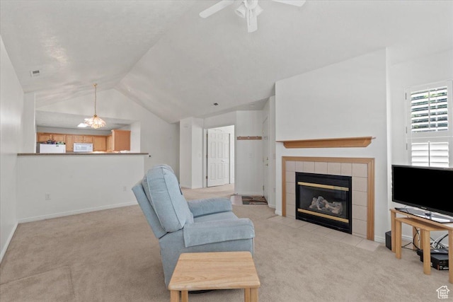 3304 S Hunter Villa Ln Unit D, West Valley City, UT 84128 - carpeted living room with vaulted ceiling, a tile fireplace, and a ceiling fan