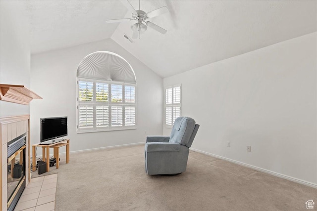 3304 S Hunter Villa Ln Unit D, West Valley City, UT 84128 - living area featuring a tile fireplace, ceiling fan, carpet floors, and vaulted ceiling