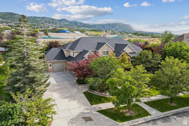 1652 E Red Tree Ct S, Draper, UT 84020 - view of front of home with a mountain view, driveway, an attached garage, and stone siding