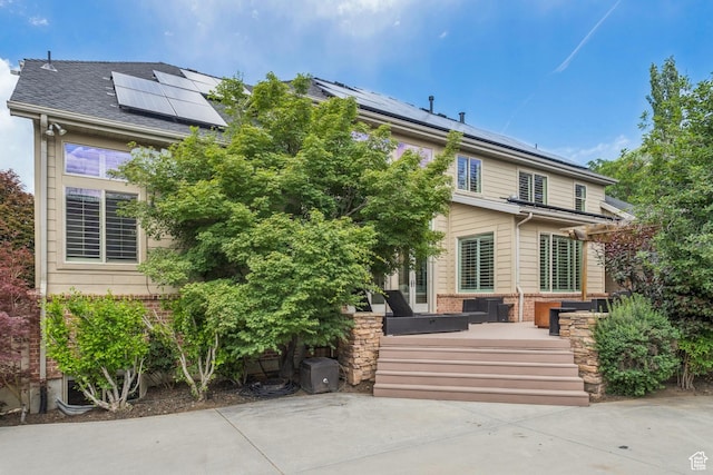1652 E Red Tree Ct S, Draper, UT 84020 - back of house featuring roof mounted solar panels and brick siding