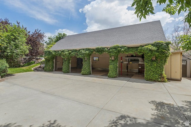 1652 E Red Tree Ct S, Draper, UT 84020 - view of front of property featuring a patio area, a shingled roof, and a storage shed