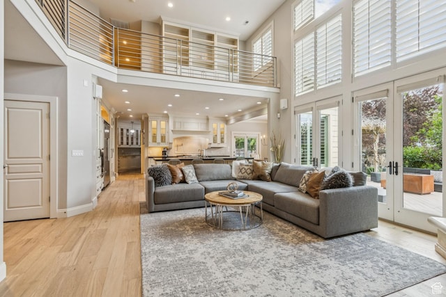 1652 E Red Tree Ct S, Draper, UT 84020 - living area with a towering ceiling, healthy amount of natural light, light wood finished floors, french doors, and recessed lighting