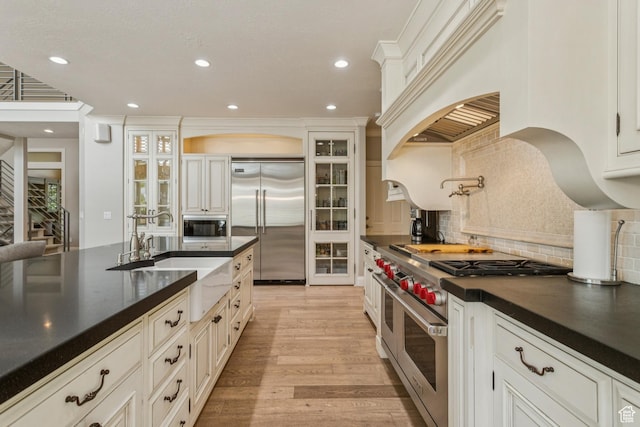1652 E Red Tree Ct S, Draper, UT 84020 - kitchen featuring built in appliances, dark countertops, recessed lighting, french doors, and tasteful backsplash