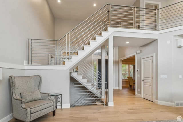 1652 E Red Tree Ct S, Draper, UT 84020 - stairs featuring a towering ceiling, wood finished floors, and recessed lighting