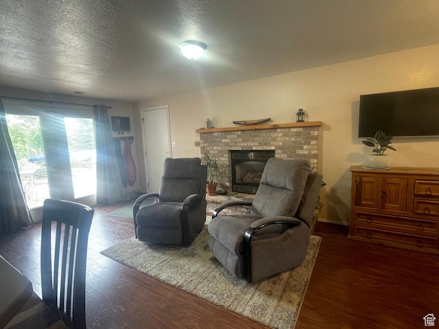 395 E Center St, Spring City, UT 84662 - living room featuring wood finished floors, a brick fireplace, and a textured ceiling