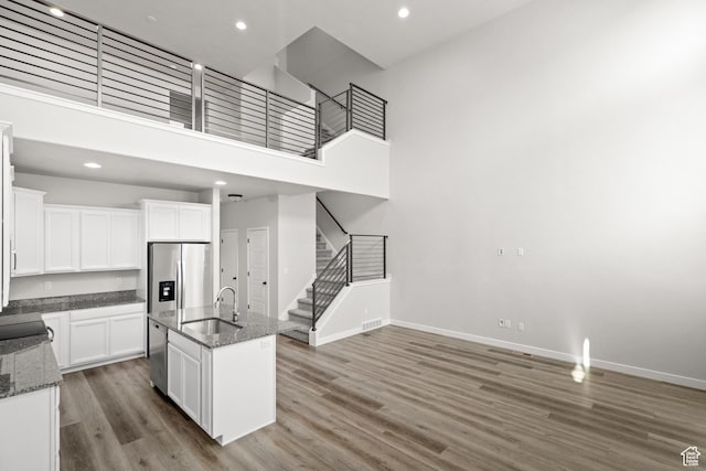 15040 S Wild Horse Way, Bluffdale, UT 84065 - kitchen featuring stainless steel appliances, wood finished floors, dark stone countertops, white cabinets, and recessed lighting