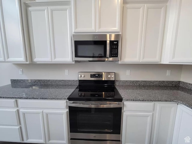 15040 S Wild Horse Way, Bluffdale, UT 84065 - kitchen with appliances with stainless steel finishes, white cabinetry, and dark stone counters