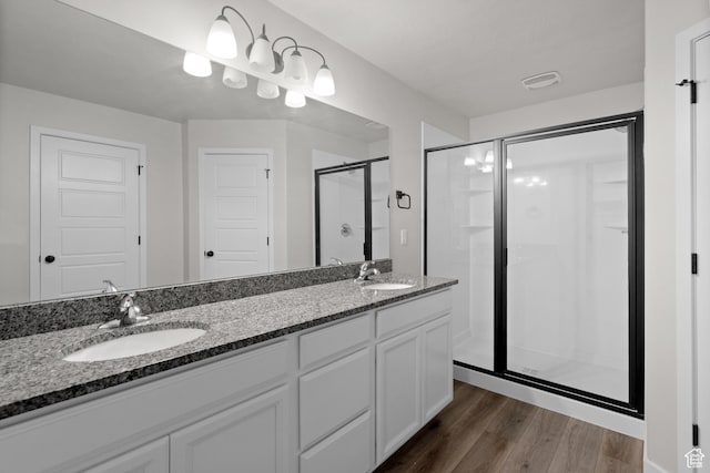 15040 S Wild Horse Way, Bluffdale, UT 84065 - bathroom with a stall shower, double vanity, and wood finished floors