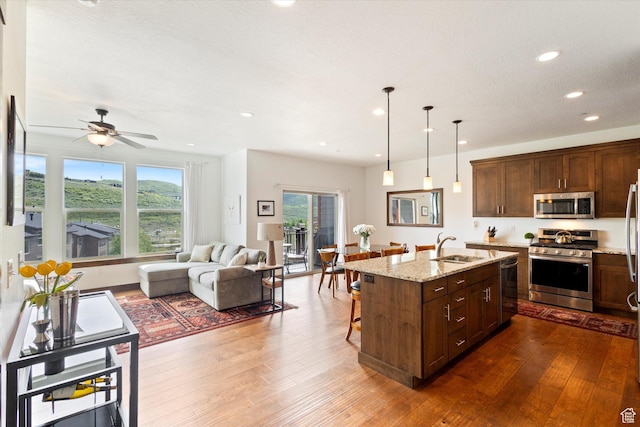 1076 W Abigail Dr, Kamas, UT 84036 - kitchen featuring stainless steel appliances, open floor plan, dark wood-type flooring, light stone countertops, and recessed lighting