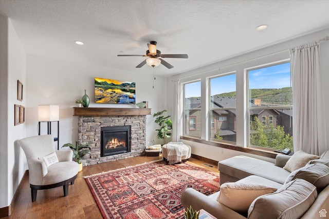 1076 W Abigail Dr, Kamas, UT 84036 - living area with a ceiling fan, a fireplace, wood finished floors, recessed lighting, and a textured ceiling