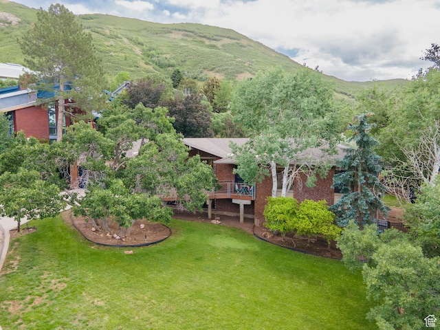 2842 E Oakbrook Cir, Salt Lake City, UT 84108 - view of grassy yard with a deck with mountain view