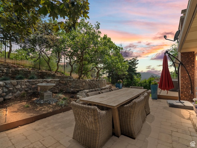 2842 E Oakbrook Cir, Salt Lake City, UT 84108 - patio terrace at dusk featuring a patio and outdoor dining area