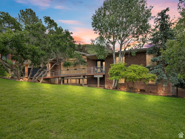2842 E Oakbrook Cir, Salt Lake City, UT 84108 - back of property with a yard, brick siding, and a deck