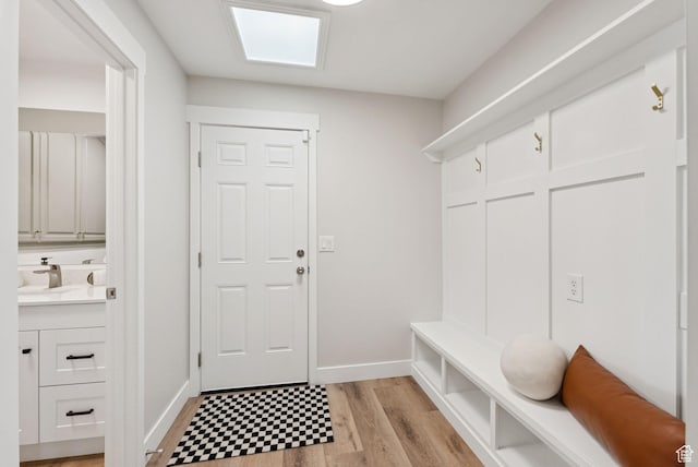 2104 W Champagne Cir, Taylorsville, UT 84129 - mudroom featuring a sink and light wood-style flooring