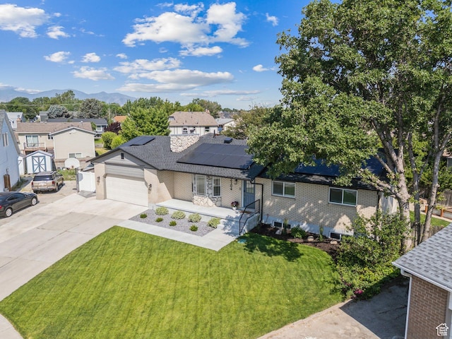 2104 W Champagne Cir, Taylorsville, UT 84129 - ranch-style house with a front yard, driveway, a residential view, brick siding, and roof mounted solar panels