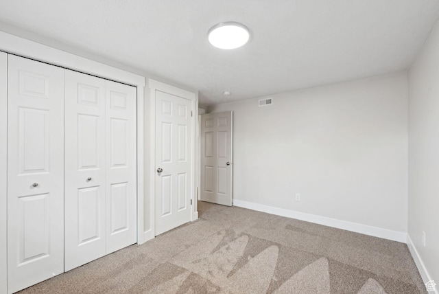 2104 W Champagne Cir, Taylorsville, UT 84129 - unfurnished bedroom featuring light colored carpet and a closet