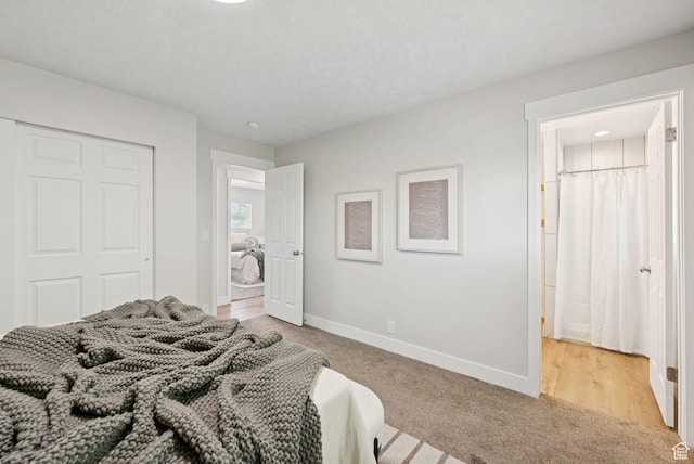 2104 W Champagne Cir, Taylorsville, UT 84129 - bedroom featuring light colored carpet, a closet, and ensuite bathroom