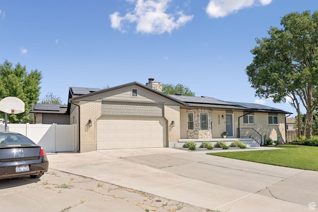 2104 W Champagne Cir, Taylorsville, UT 84129 - ranch-style home with a garage, concrete driveway, solar panels, and brick siding