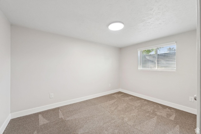 2104 W Champagne Cir, Taylorsville, UT 84129 - carpeted empty room featuring baseboards and a textured ceiling