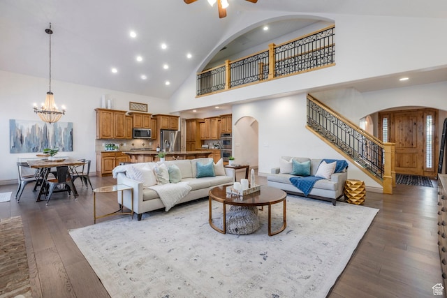 10677 S Amberley Ln E, Sandy, UT 84094 - living area with arched walkways, stairs, a chandelier, high vaulted ceiling, and dark wood finished floors