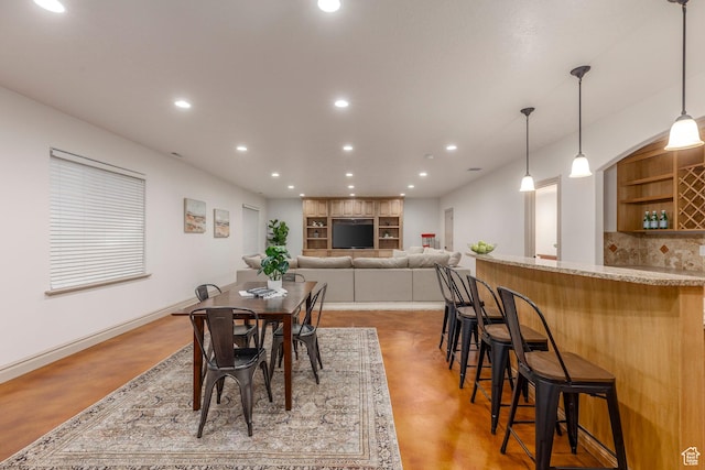 10677 S Amberley Ln E, Sandy, UT 84094 - dining room with finished concrete flooring, recessed lighting, and bar
