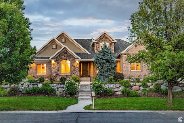 10677 S Amberley Ln E, Sandy, UT 84094 - view of front of property with stone siding, stucco siding, and a front lawn