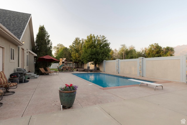 10677 S Amberley Ln E, Sandy, UT 84094 - view of swimming pool with a playground, a patio, a diving board, and grilling area