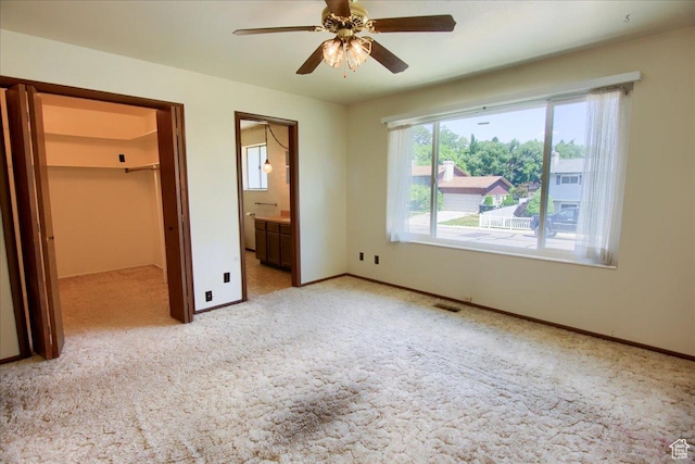 1063 W 1100 N, Provo, UT 84604 - unfurnished bedroom with light carpet, a walk in closet, connected bathroom, a closet, and a ceiling fan