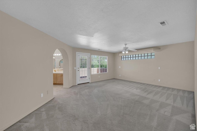1912 W Rivers Edge Ln, St George, UT 84770 - empty room with a ceiling fan, light carpet, a textured ceiling, and arched walkways