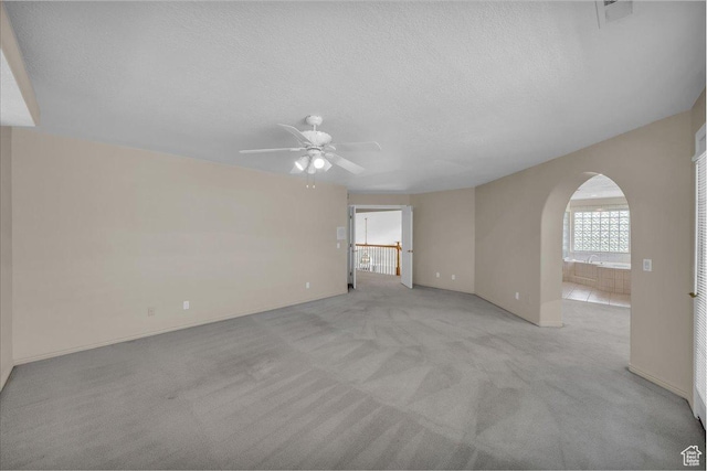 1912 W Rivers Edge Ln, St George, UT 84770 - carpeted empty room featuring arched walkways, a ceiling fan, and a textured ceiling