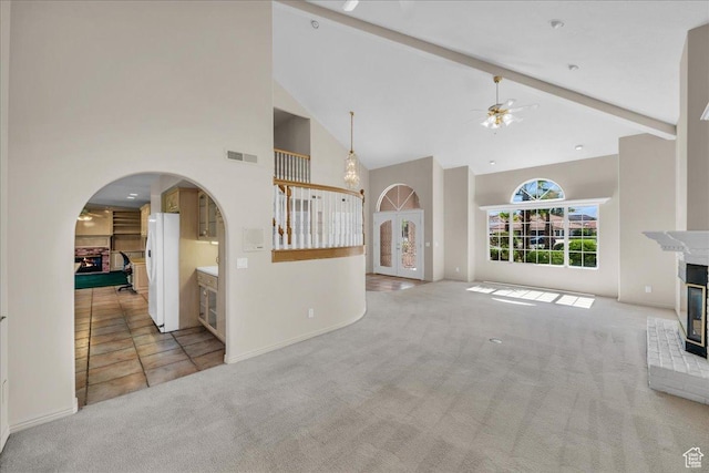 1912 W Rivers Edge Ln, St George, UT 84770 - unfurnished living room featuring a multi sided fireplace, high vaulted ceiling, carpet, ceiling fan, and arched walkways
