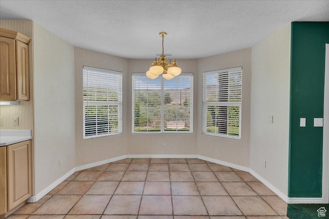 1912 W Rivers Edge Ln, St George, UT 84770 - unfurnished dining area featuring a chandelier, a textured ceiling, plenty of natural light, and light tile patterned floors