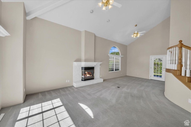 1912 W Rivers Edge Ln, St George, UT 84770 - unfurnished living room with high vaulted ceiling, ceiling fan, carpet floors, healthy amount of natural light, and a fireplace