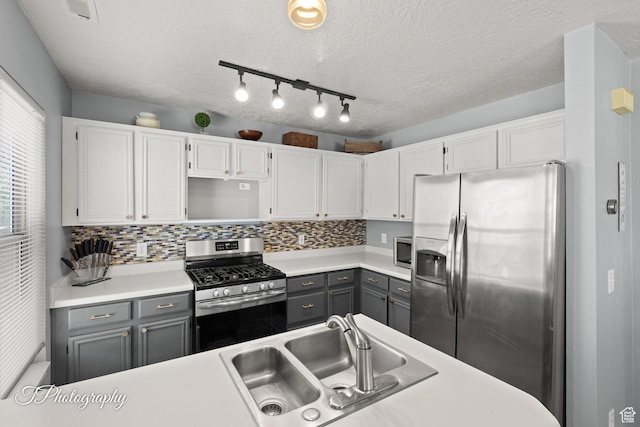 1161 S 860 W, Cedar City, UT 84720 - kitchen featuring appliances with stainless steel finishes, gray cabinetry, white cabinetry, light countertops, and a textured ceiling