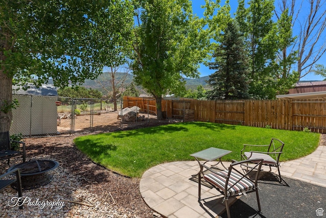 1161 S 860 W, Cedar City, UT 84720 - fenced backyard with a fire pit, a patio, and a mountain view