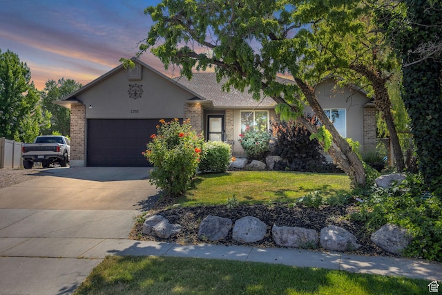 2352 N 1160 W, Clinton, UT 84015 - view of front of home with an attached garage, driveway, brick siding, and a front yard