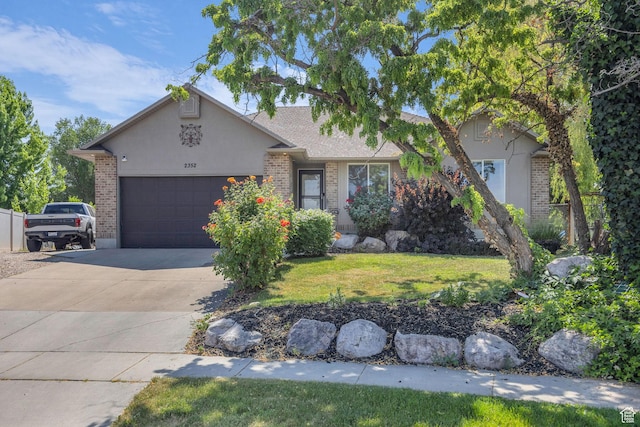 2352 N 1160 W, Clinton, UT 84015 - view of front of home featuring a garage, concrete driveway, brick siding, and stucco siding