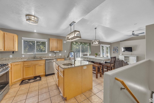 2352 N 1160 W, Clinton, UT 84015 - kitchen with stainless steel appliances, light brown cabinets, plenty of natural light, and a textured ceiling