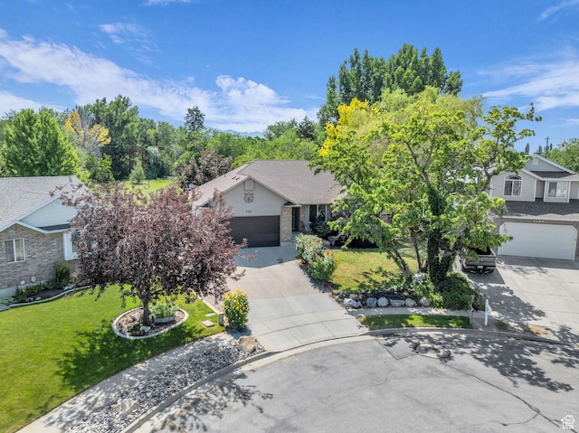 2352 N 1160 W, Clinton, UT 84015 - obstructed view of property featuring driveway, a front lawn, and a garage