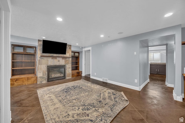 2352 N 1160 W, Clinton, UT 84015 - living room featuring a fireplace, built in features, recessed lighting, and concrete floors