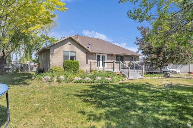 2352 N 1160 W, Clinton, UT 84015 - back of property featuring a wooden deck and a trampoline