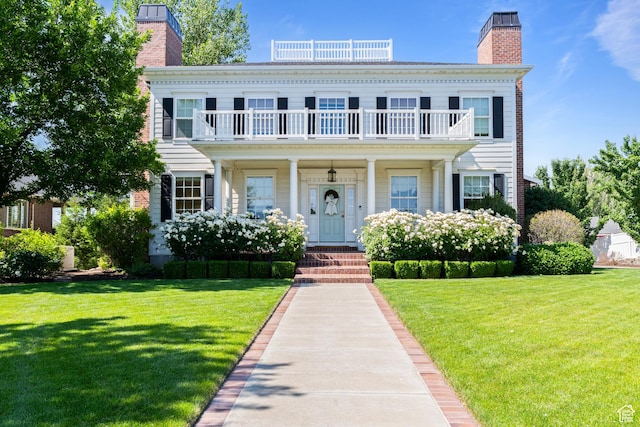 1254 W 475 S, Farmington, UT 84025 - view of front facade featuring a balcony, a chimney, and a front lawn