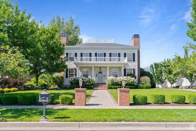 1254 W 475 S, Farmington, UT 84025 - view of front of home with a balcony, a chimney, and a front lawn