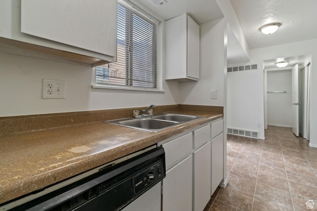 814 E Meadow Pine Ct, Salt Lake City, UT 84106 - kitchen with white dishwasher, white cabinetry, dark countertops, and light tile patterned flooring