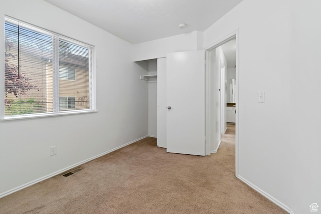 814 E Meadow Pine Ct, Salt Lake City, UT 84106 - unfurnished bedroom featuring light carpet, multiple windows, and a closet