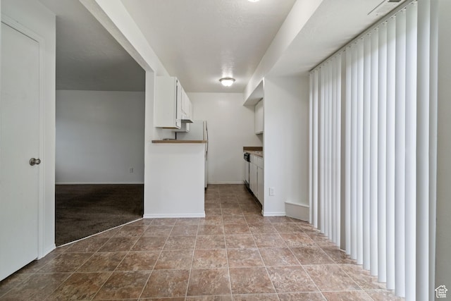 814 E Meadow Pine Ct, Salt Lake City, UT 84106 - kitchen with white cabinetry, freestanding refrigerator, and carpet flooring