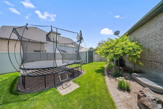 3116 W Hayden Ridge Way, Riverton, UT 84065 - fenced backyard featuring a trampoline and a storage unit