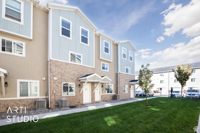 43 E 670 N, Vineyard, UT 84059 - view of front facade with brick siding, a front lawn, and board and batten siding